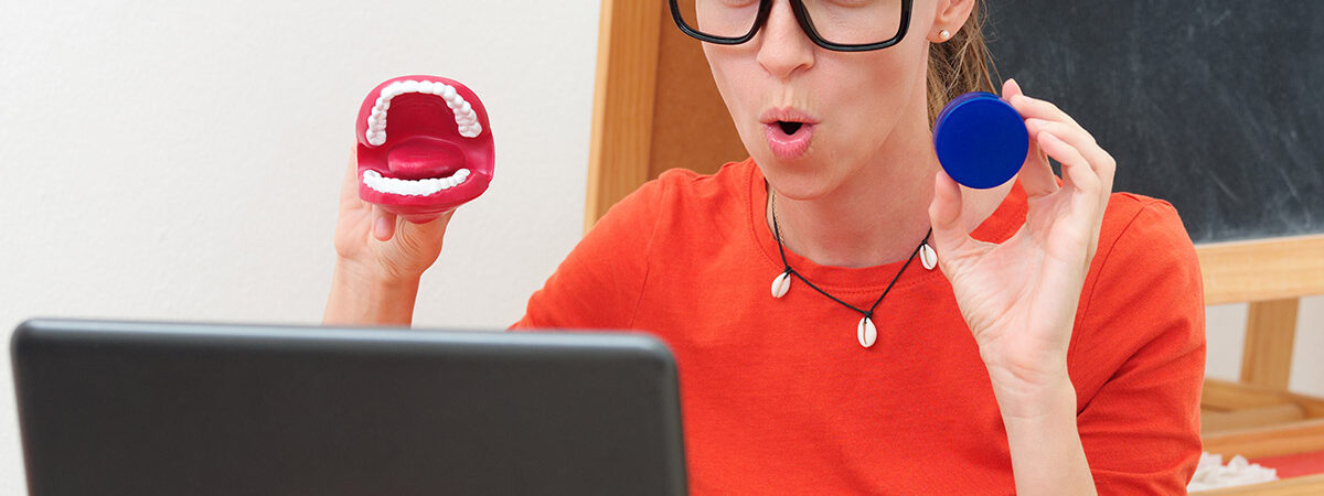 Speech therapist conducts an online lesson with a laptop. Speech therapist conducts an online lesson with a laptop webcam.